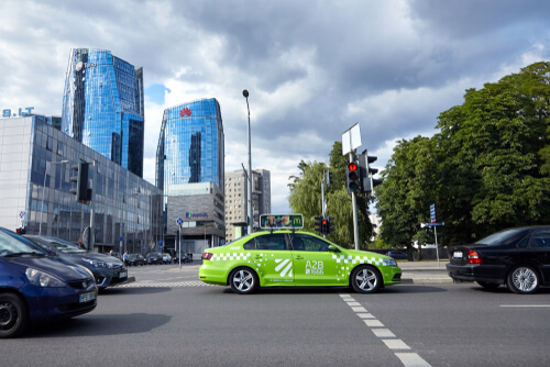 Always use official taxi services or ride-sharing apps like Bolt, as unofficial taxis at the airport often overcharge tourists by 3-4 times the normal rate. Look for yellow/blue licensed taxis with visible meters, or better yet, pre-book your transfer.